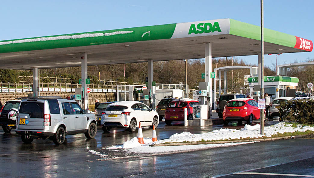 Merthry Tydfil, Wales UK: December 28, 2017: A self-service petrol station at an Asda supermarket  The snow has fallen and people are refuelling their cars incase the conditions get worse  