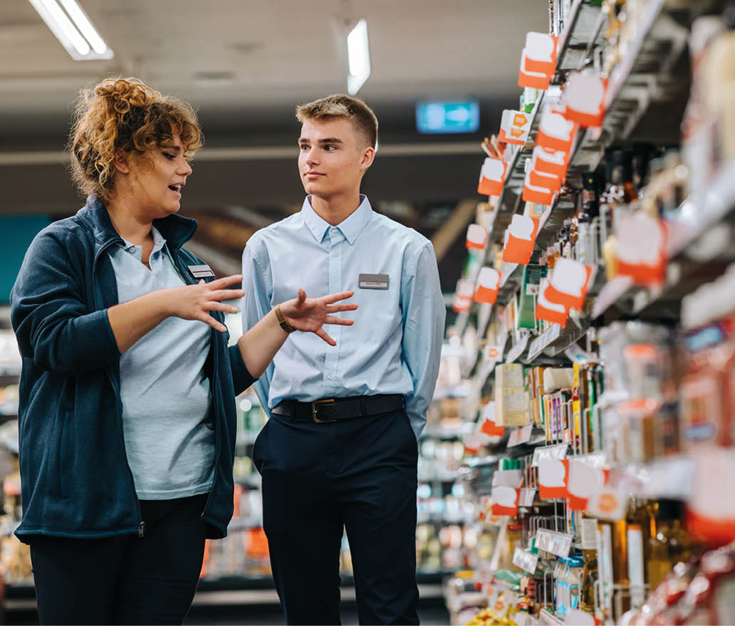 Store manager training young worker  Supermarket manager giving training to a trainee 