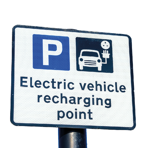 Recharging Point for Electric Vehicles Sign against Clear Sky