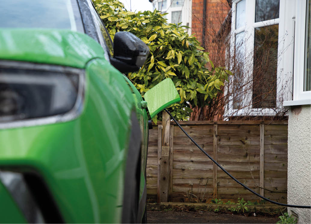 Green Electric Car On Charge At Home