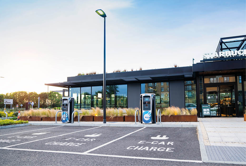 London, United Kingdom - May 28 2020: Electric vehicle charging station in front of Starbucks cafe 