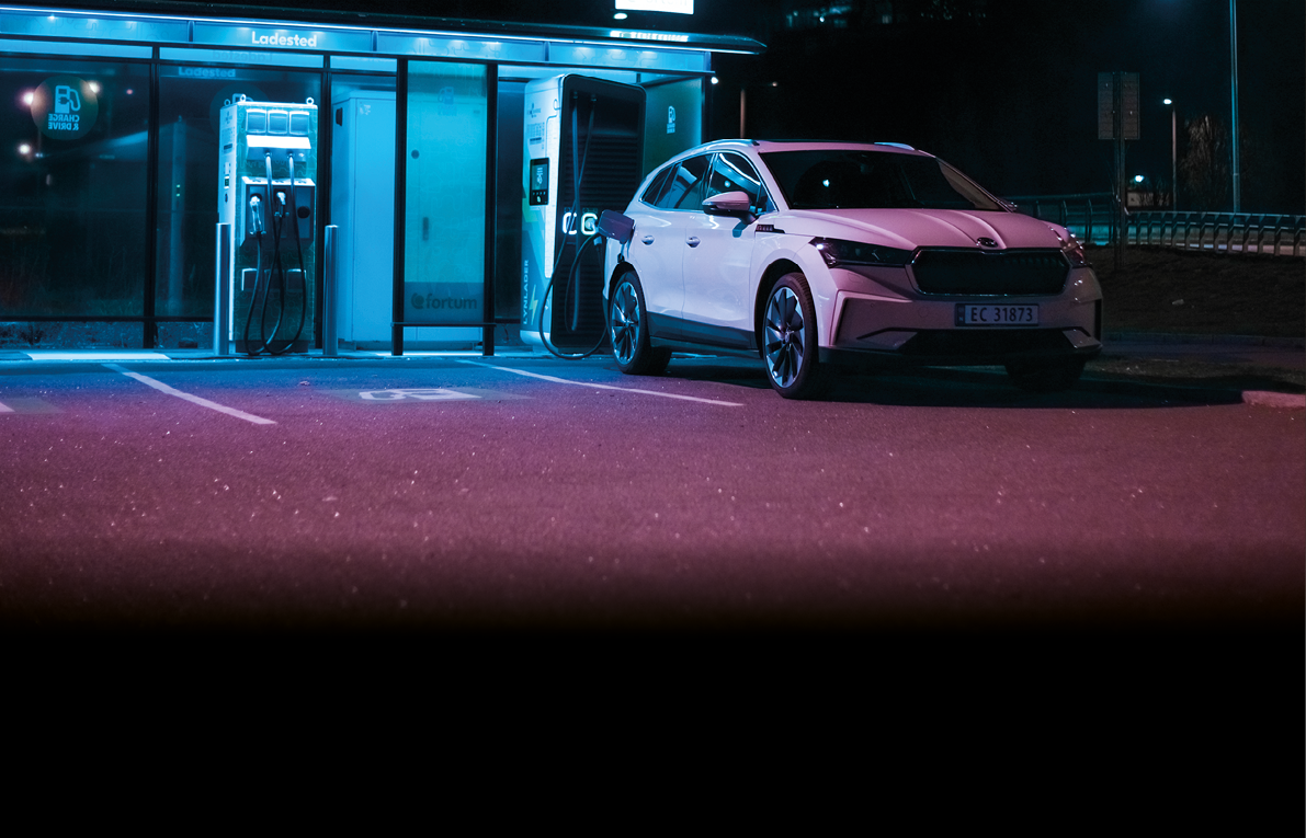 Tønsberg, Norway - may 15, 2021: white Skoda enyaq IV is a suv electric car  New car on a charging station during the night