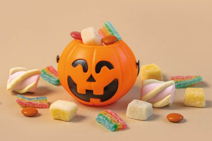 Halloween Jelly Beans. Happy Halloween Party Border Beige Background. Aesthetic Accessories Banner. Spooky Orange Pumpkin Candy Bucket. Modern Holiday Design. Thanksgiving Trendy Fall Poster