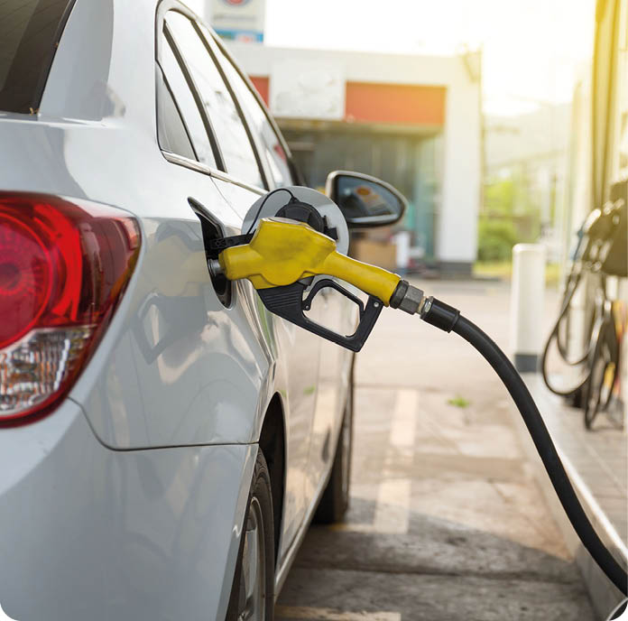 Transportation and ownership concept - woman pumping gasoline fuel in car at gas station during Russia-Ukraine war that oil or gasohol price high. 