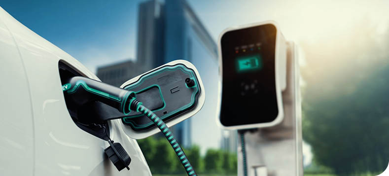 Electric car plug in with charging station to recharge battery with electricity by EV charger cable in eco green city park. Future innovative EV car using alternative clean energy reducing CO2. Peruse