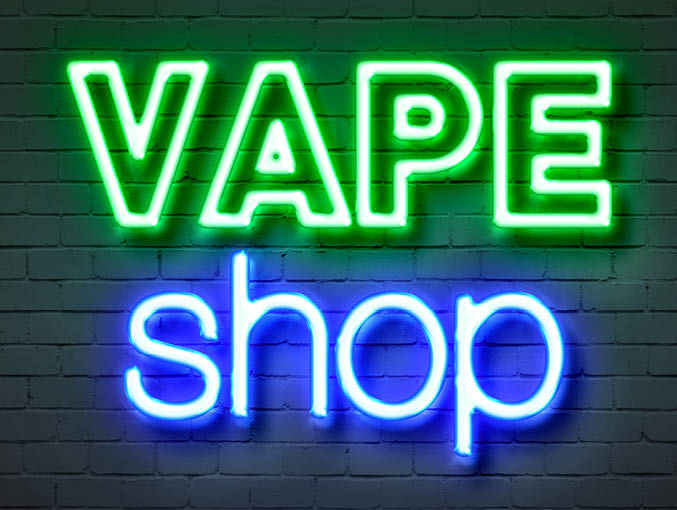 Vape shop neon sign on brick wall background
