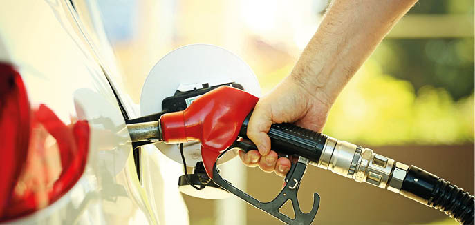 Hand refilling the car with fuel at the refuel station