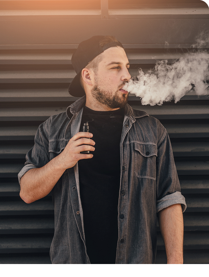 Young handsome man smoke with vape near black wall