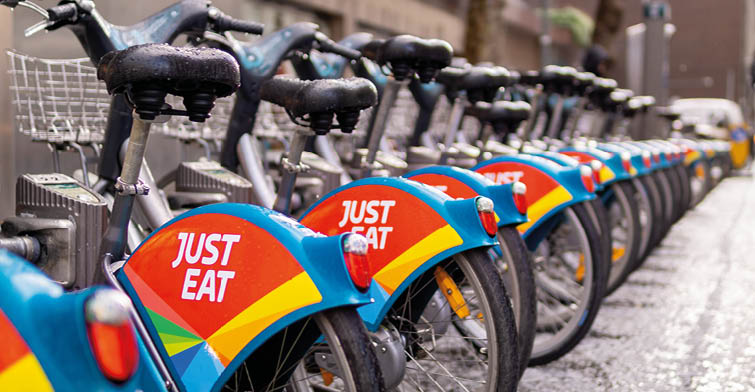 Dublin, Ireland - 2019 2 April : A fleet of public bikes in the city centre with “Just Eat" sign
