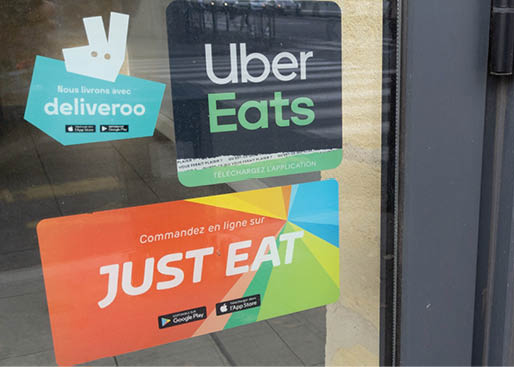 Bordeaux , Aquitaine France - 11 05 2021 : Uber eats deliveroo and just eat sign brand and text logo front of windows of restaurant company shop food delivery food