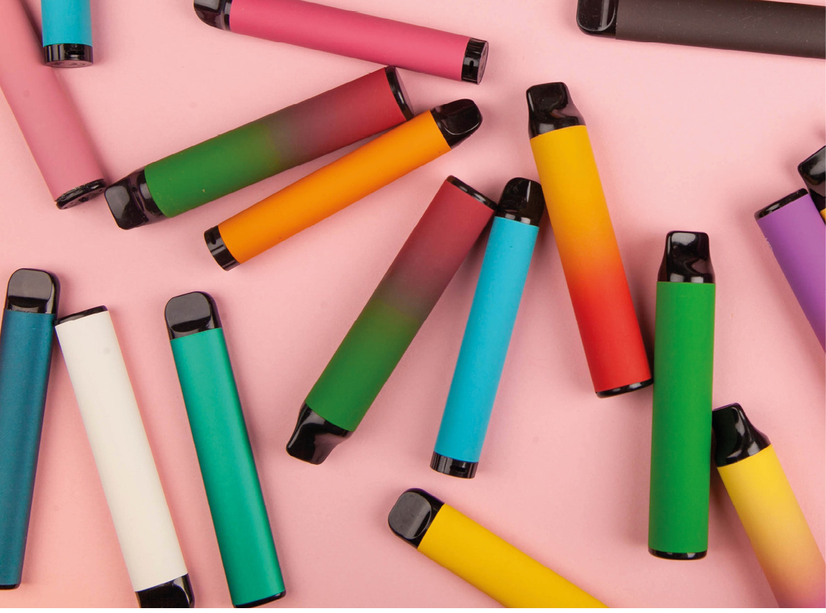 Disposable e-cigarettes with different flavors in pink. The concept of modern smoking, vaping and nicotine.