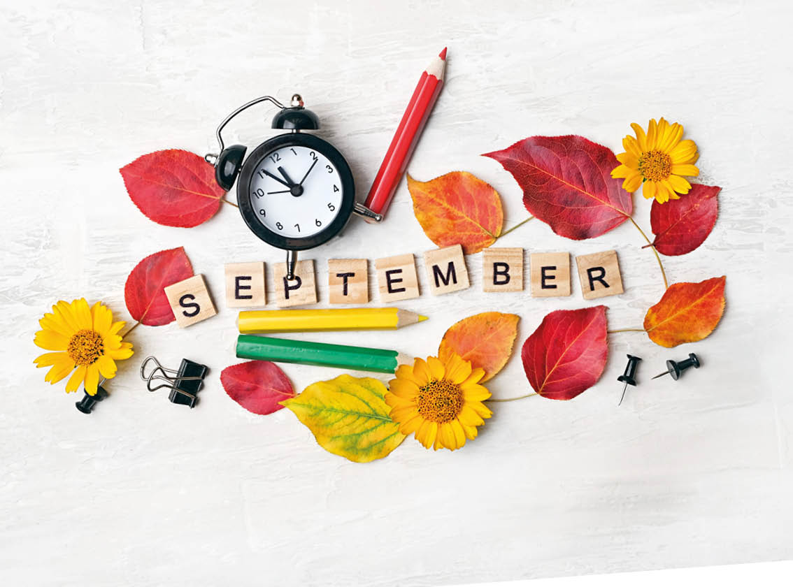 September time. stationery, pencil, alarm clock, flowers, autumn leaves. education, starting school, back to school Concept. symbol of 1 september, beginning of school year. flat lay.