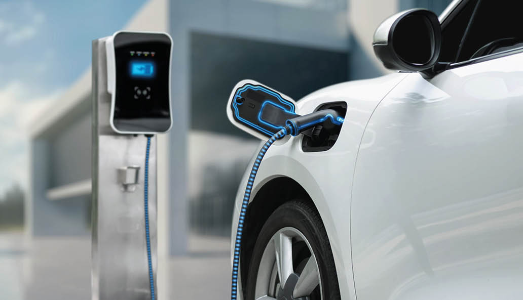 Innovative electric car connected to charging station with future architecture building background. Technological advancement rechargeable EV car using alternative clean and sustainable energy. Peruse