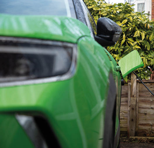 Green Electric Car On Charge At Home