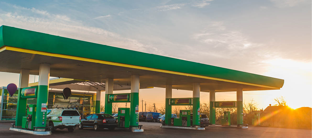 wide view of gas station on sunset copy space