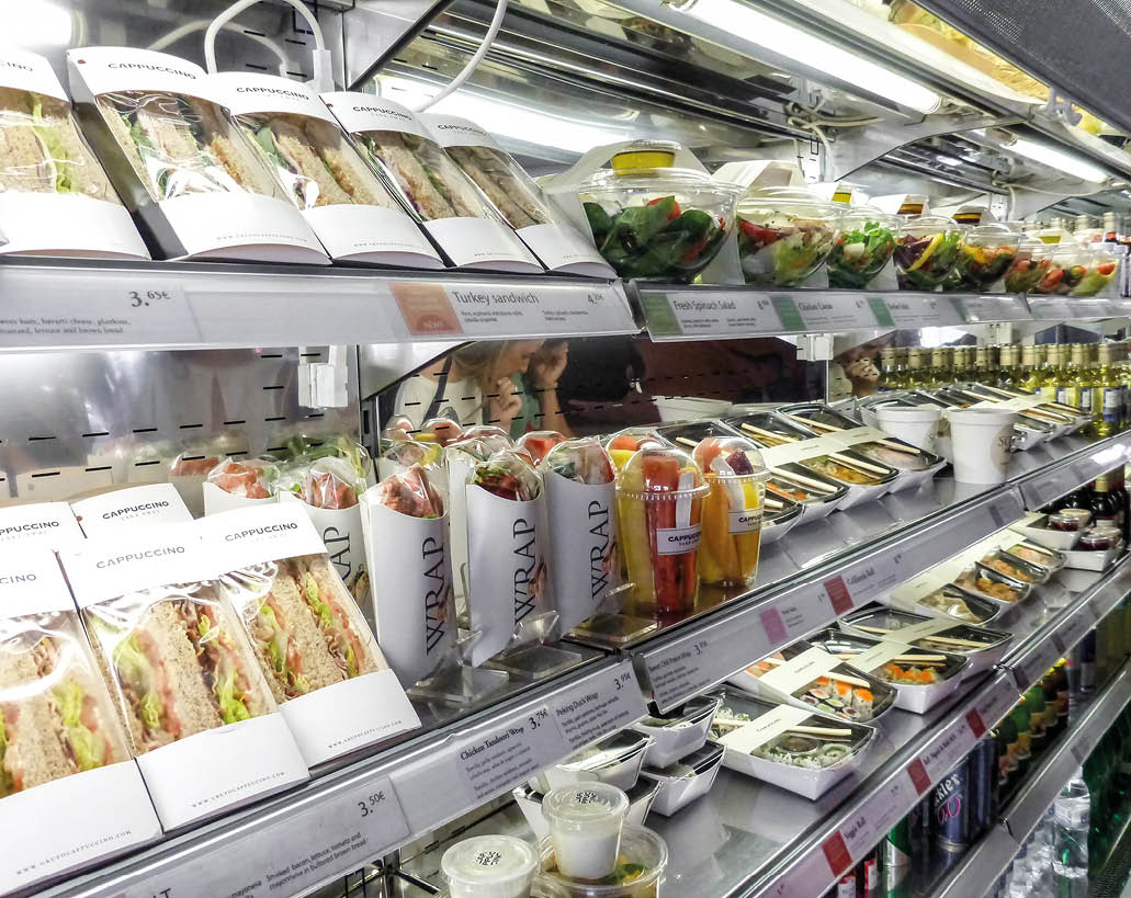 Madrid, Spain - May 10 2019 - Bad habits of the human in modern times: shelf full of pre-packaged foods, ready to eat  Plastic abuse to contain ready-to-eat salads, sandwiches, fruit and vegetables 