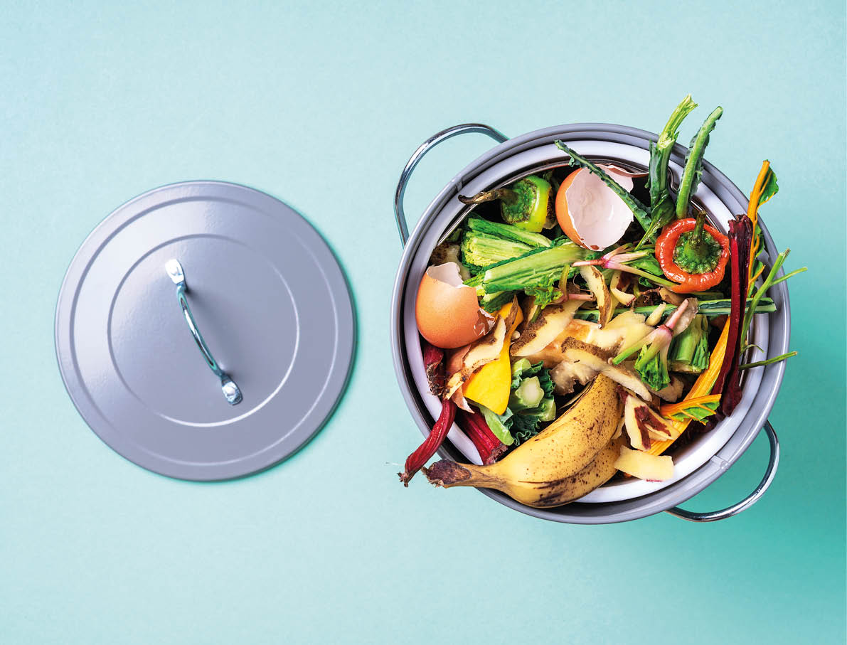 Garbage sorting  Organic food waste from vegetable ready for recycling in compost bin on blue backgrond  Top view  Sustainable and zero waste living  Environmentally responsible behavior, ecology