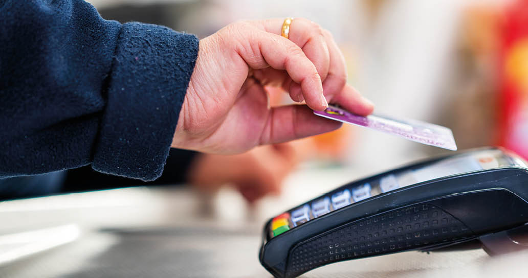 Close up of cashier is using contactless credit card pos terminal to getting the payment