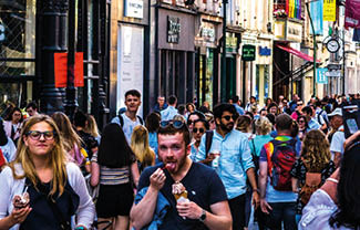 Tourists and locals crowd the street in Dublin Ireland during the summer holidays. June of 2018