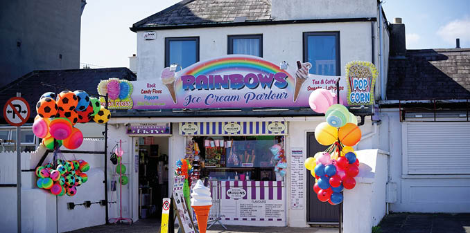 BRAY, IRELAND - Apr 03, 2021: A shop with ice cream, snacks and colorful toys on sunny day Open local business is waiting for customers in Bray, Co  Wicklow, Ireland 