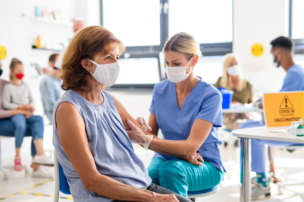 Woman with face mask getting vaccinated, coronavirus, covid-19 and vaccination concept 