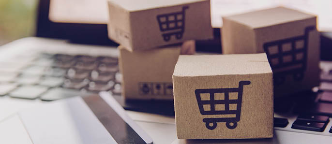 Online shopping - Paper cartons or parcel with a shopping cart logo and credit card on a laptop keyboard  Shopping service on The online web and offers home delivery 