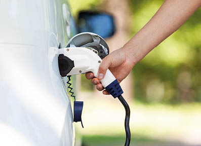 Electric car battery charging at charge station in the nature