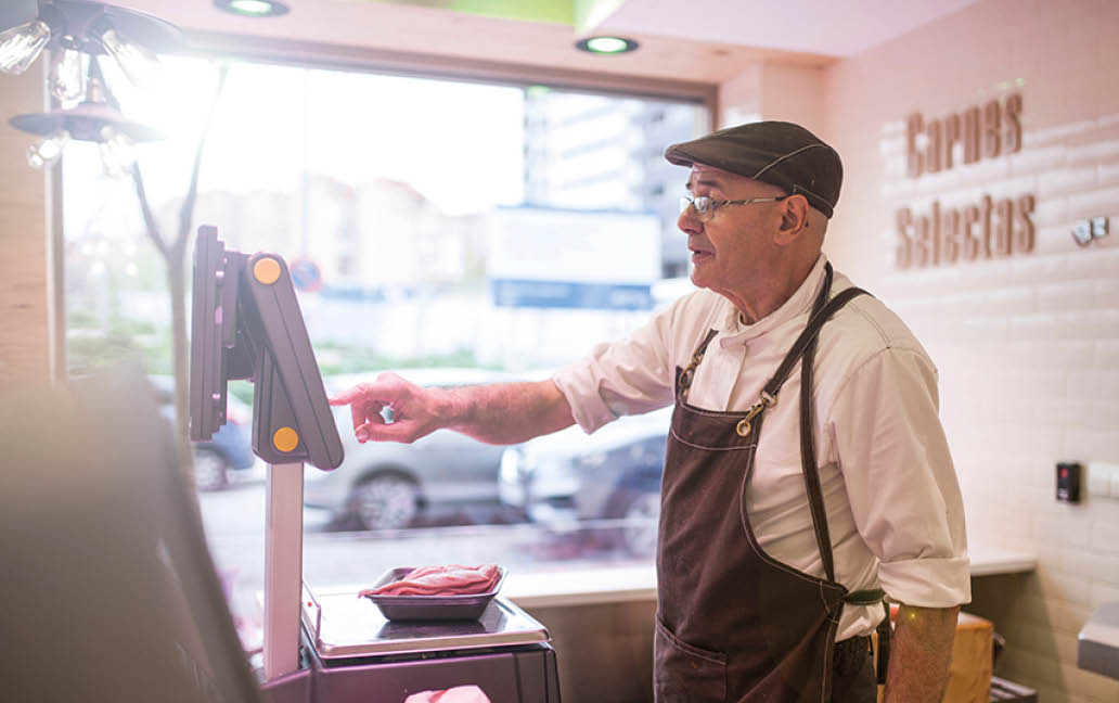 butcher weighing the meat and charging