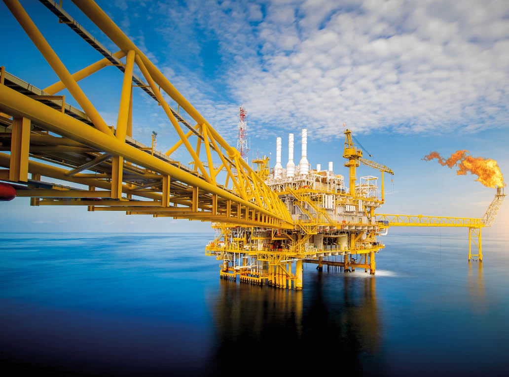 Large Offshore oil rig drilling platform at sunset and beautiful sky in the gulf of Thailand