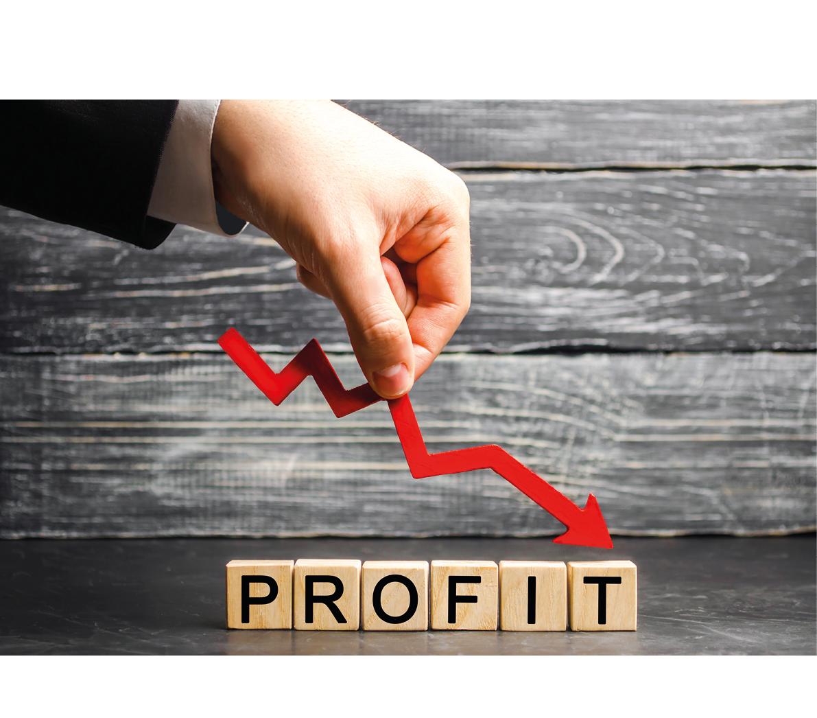A businessman holds a red arrow to down and the inscription “profit". Unsuccessful business and poverty. Profit decline. Loss of investment. Low wages. Economic crisis. Financial market fall