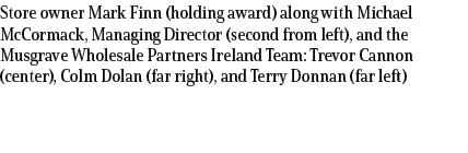 Store owner Mark Finn (holding award) along with Michael McCormack, Managing Director (second from left), and the Mus...