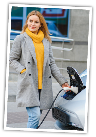 Woman charging electro car at the electric gas station