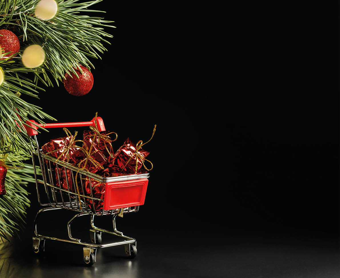 Christmas tree with shiny red festive balls on a black background  Gift and present for the holiday  supermarket trolley  New and Year and Christmas  Garland and bokeh lights 