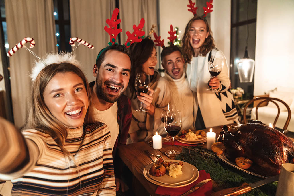 Photo of nice excited people taking selfie photo and laughing while having Christmas dinner in cozy room