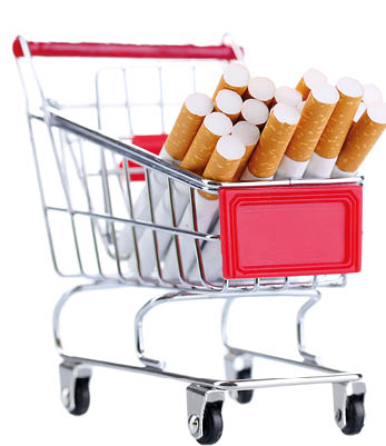 Cigarettes in shopping cart isolated on white
