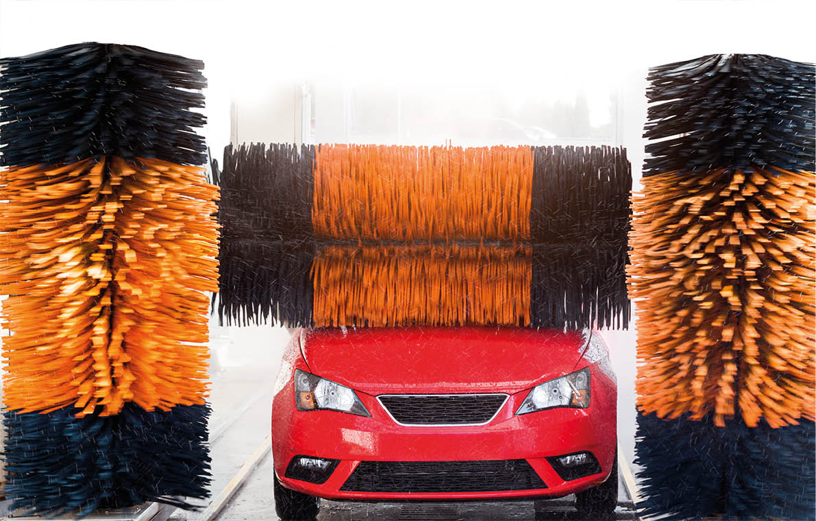 Car wash, red car in automatic car wash, rotating yellow and blue brush  Washing vehicle 