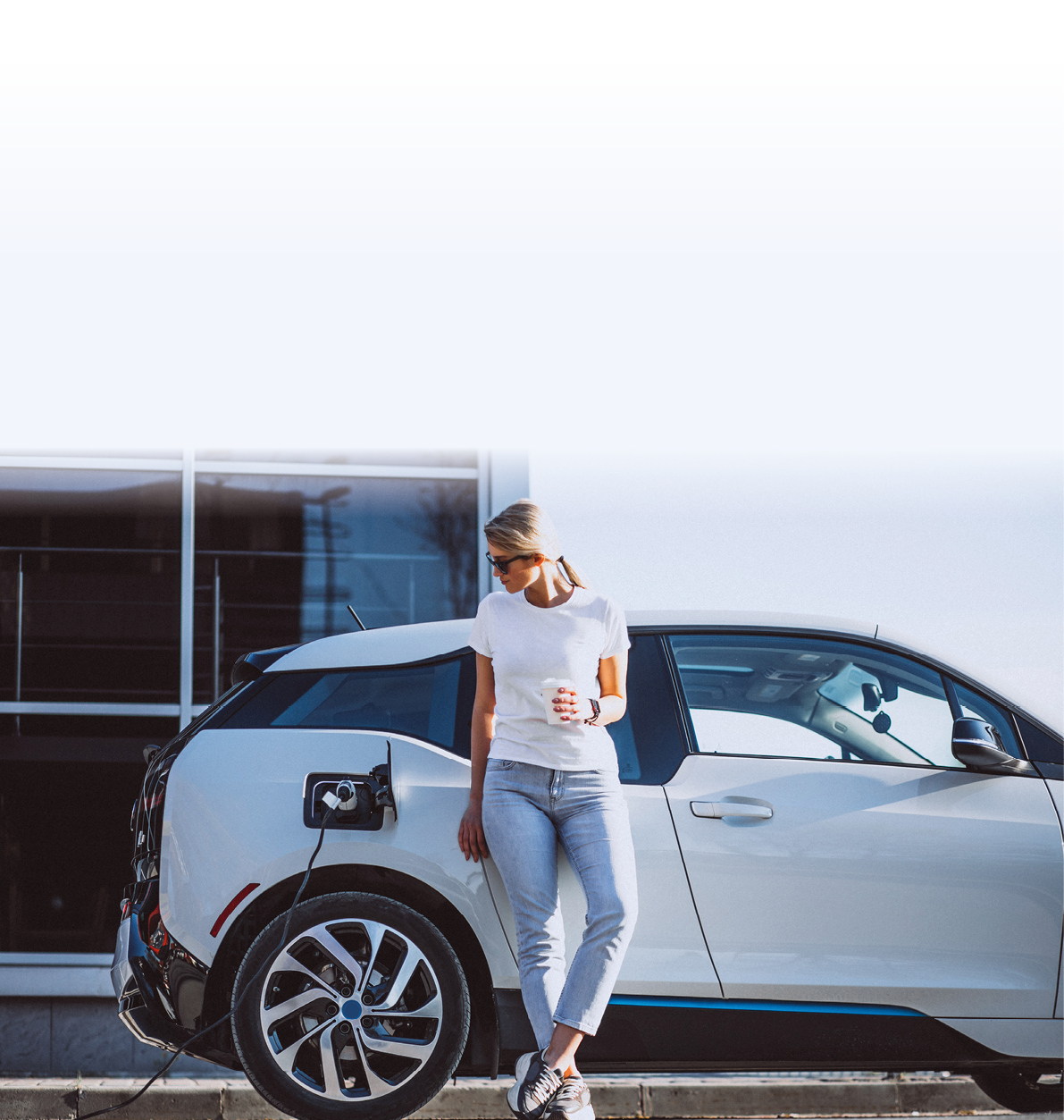 Woman charging electro car at the electric gas station