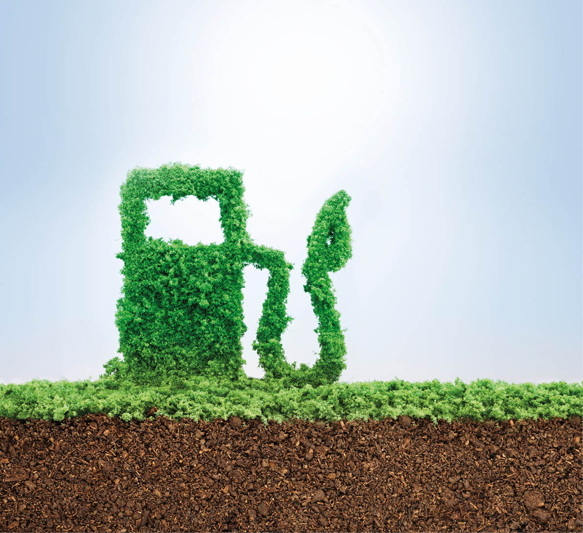 Green energy concept with grass growing in shape of fuel pump 