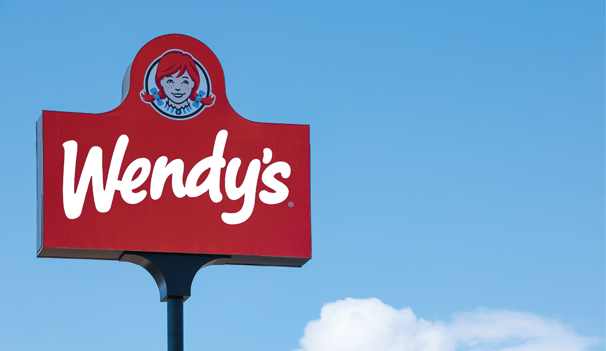 Las Vegas, NV 2-13-2021: Big sign of Wendy’s fast food restaurant at its location on W Sahara Avenue. The chain is headquartered in Dublin, Ohio. Isolated on blue sky with clouds in the background.