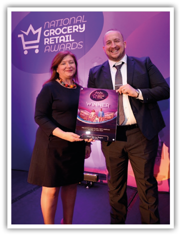 A person and person holding a sign Description automatically generated