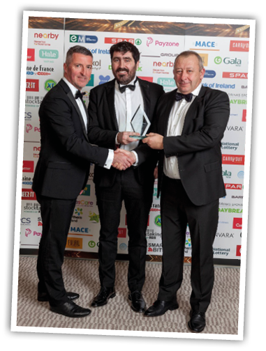 A group of men in suits shaking hands Description automatically generated