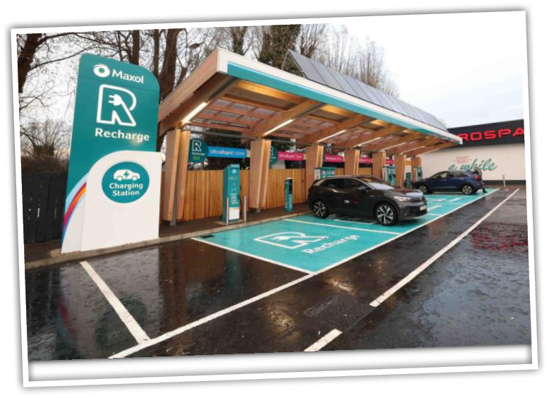 A car charging station with cars parked in front of it Description automatically generated