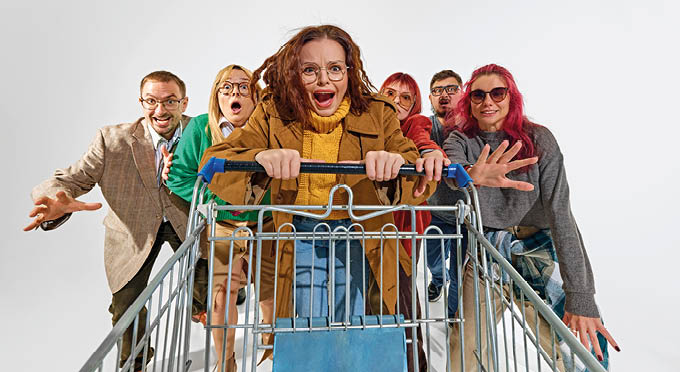 Group of super emotional and excited people pushing shopping cart forward with craziness. Competition for best deals. Concept of Black Friday, Cyber Monday, shopping