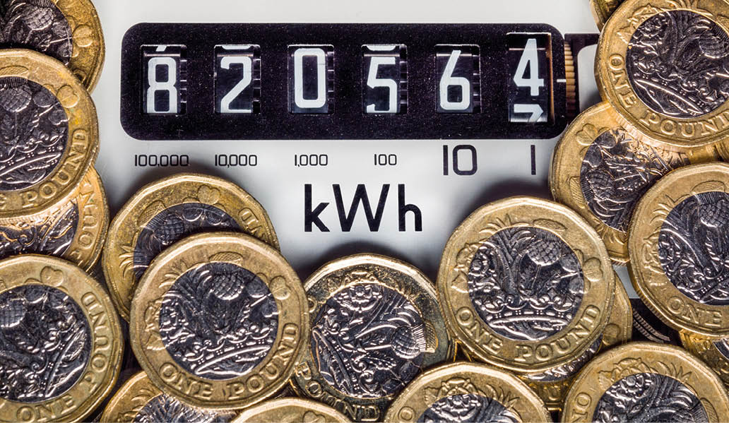 London, UK, September 7th 2023:Electricity meter and kWh symbol surrounded with one pound coins. Concept for energy supplier, high bills, price rise, cost of living and Winter fuel payments.