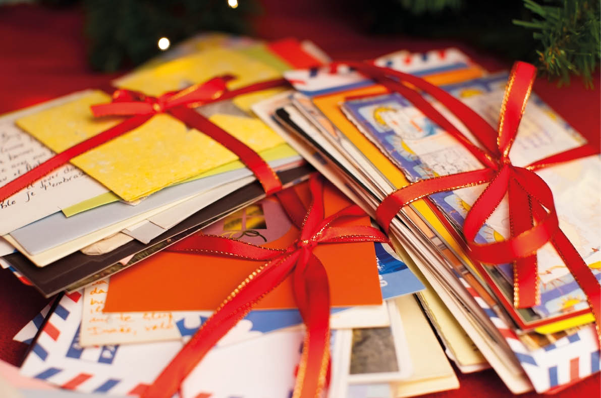 Christmas letters tied with red ribbon.