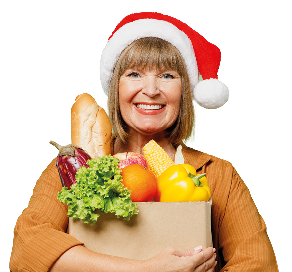 Elderly smiling happy cheerful woman wear brown shirt casual clothes red Santa hat hold shopping paper bag with food products look camera isolated on plain green background. Delivery service from shop