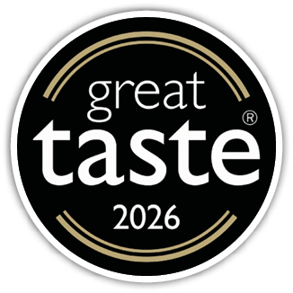A circular black badge with gold accents featuring the words great taste and the year 2026 in white text. Description generated by AI