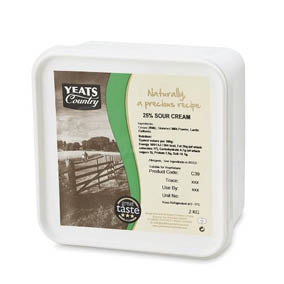 A square white container of Yeats Country 25% sour cream with a vintage-style label featuring a countryside fence and nutritional information. Description generated by AI