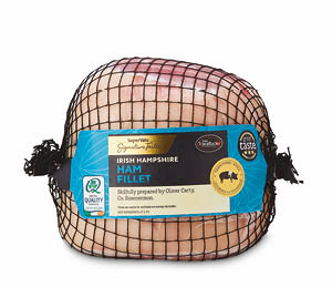 A packaged Irish Hampshire ham fillet wrapped in black netting with a blue label indicating quality and preparation details. Description generated by AI