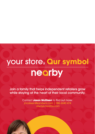 A person wearing a dark polo shirt with a “nearby" logo stands in front of a red and yellow promotional backdrop and a storefront with the same branding, encouraging independent retailers to join a local community initiative. Description generated by AI